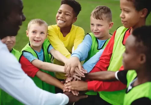junior-football-team-stacking-hands-before-match_53876-139584 (1)